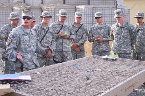 2LT John Deal, a platoon leader, explains mission using a sand table, under the watch of BG Joseph Votel, CJTF-82 deputy commander of operations May 2007.  US Army Image