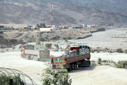 Jingle trucks maneuver in to place for inspection outside of Forward Operating Base Torkham, in Nangarhar province, Afghanistan, Sept. 9, 2013. The main supply route is designated to move goods through the Torkham Gate, in and out of Afghanistan and Pakistan. US Army Image