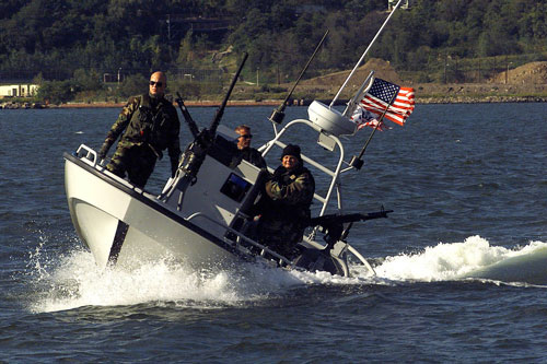 A Coast Guard Port Security Unit boat crew, from Fort Eustis, VA, patrols the Hudson River 26 September 2001. Members from the Port Security Units, mostly Coast Guard Reservists, were deployed to New York to provide on-water security after the World Trade Center attack September 11.  U.S. Coast Guard Photo.