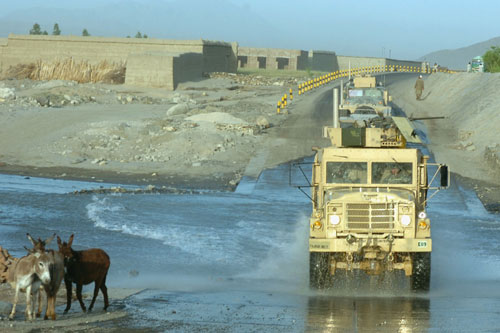E Company, 710th Brigade Support Battalion convoy delivers ammo, food, mail and other supplies to the frontline along the Pech River Road, one of the most dangerous roads in east Afghanistan in 2007. US Army Image.