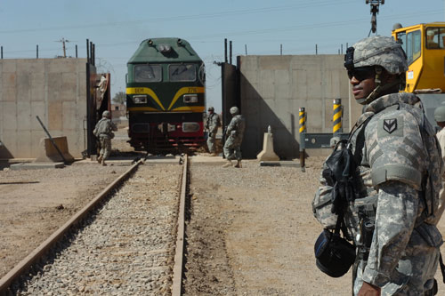 MAJ Baldwin, the mobility chief for the 1st Sustainment Brigade, looks on as Soldiers from 2nd Battalion, 11th Field Artillery Regiment opened the rail gates at Camp Taji from Baghdad on 10 March 2008. US Army Image.