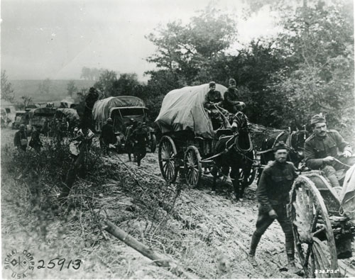 Liberty Trucks and wagon share the road and the load moving Soldiers and supplies to the Western Front in 1918 – Army Signal Corps Photo