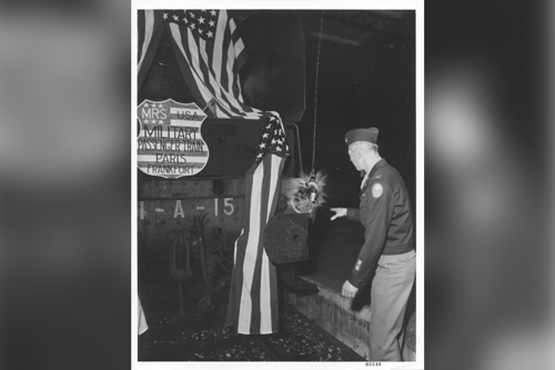 Col Frank Hosak, U.S. Army Transportation Corps christens the first train to leave Paris for Germany at Care De L'est Station in 1945.  Part of the research collection of the U.S. Army Transportation Museum.