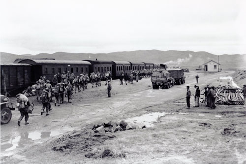 Allied Troops loading a passenger train in Kurming, China during World War II.  Part of the research collection of the U.S. Army Transportation Museum.