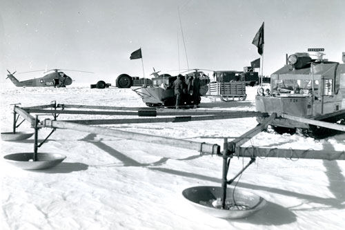 Project Lead Dog, Two M-29C Weasels (one with crevasse detector) and two H-34s of the Transportation Research Operations Group prepare for an Arctic convoy in Greenland in June 1960.