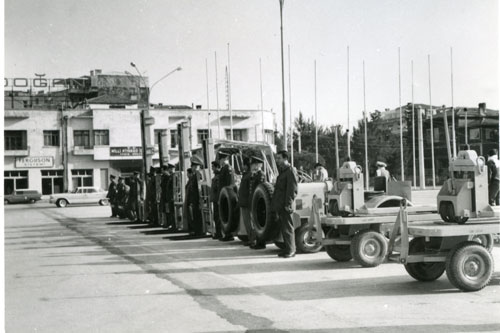 U.S. military and civilian personnel of Detachment 33-2, Izmir Port stand beside units as part of an inspection of United States Logistics Group in Turkey circa 1962. Part of the research collection of the U.S. Army Transportation Museum.