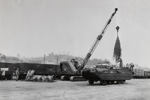 558th Amphibious Truck Co. DUKW being offloaded by crawler crane for loading onto Railcars in Korea. Part of the research collection of the U.S. Army Transportation Museum.