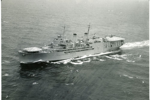 USNS Corpus Christie Bay underway to Vietnam with UH-1 sitting on aft flight deck. The 1st Transportation Battalion served aboard creating a floating rotary wing aircraft maintenance facility. A model of the ship can be found on display at the U.S. Army Transportation Museum.