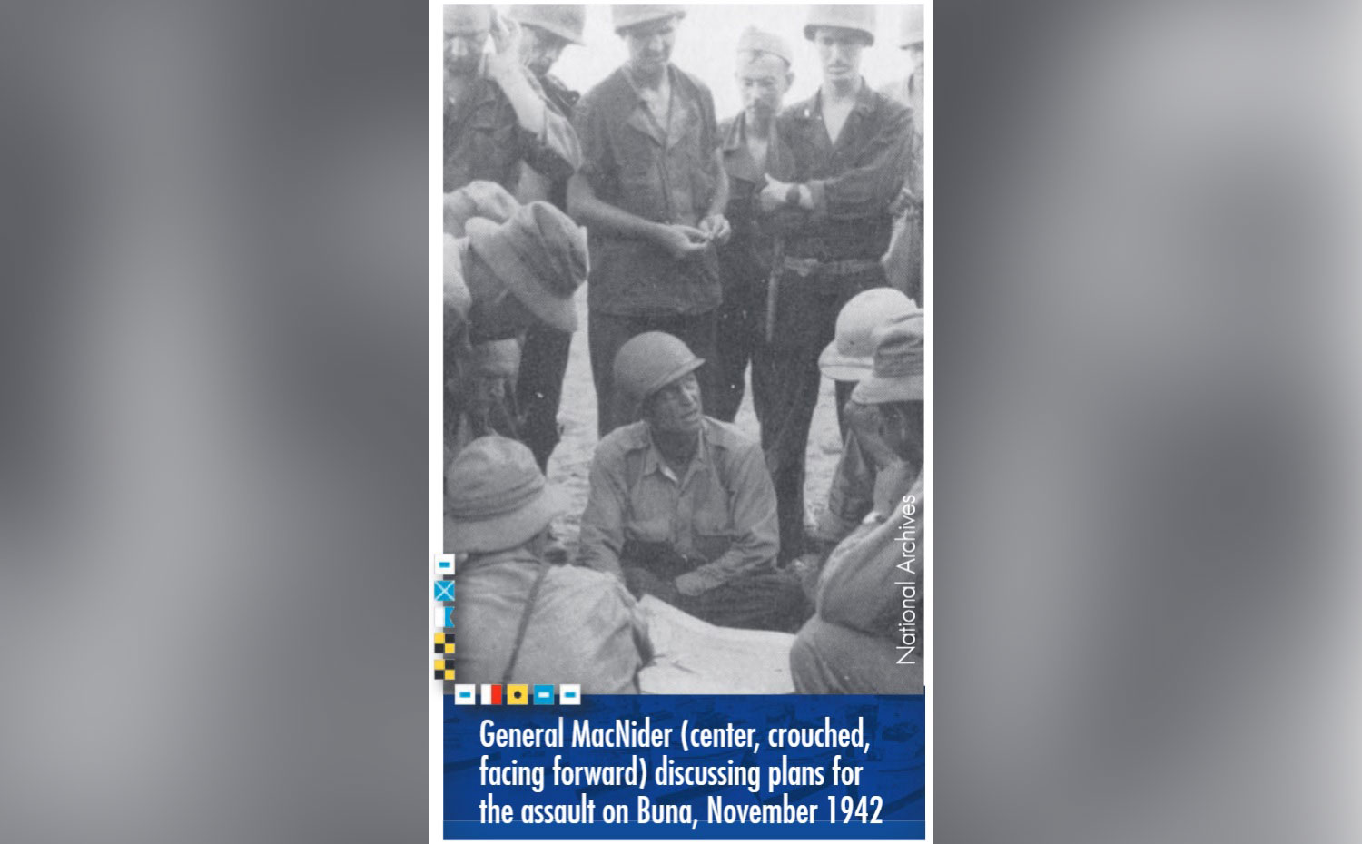 General MacNider (center, crouched, facing foward) discussing plans for the assult on Buna, November 1942. Photo from the National Archives.