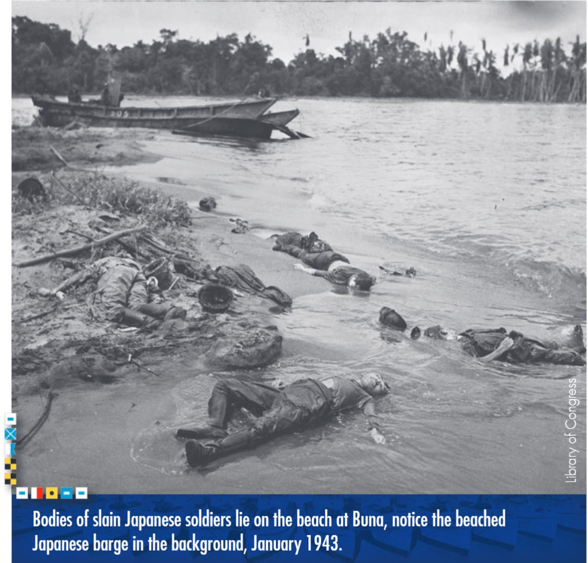 Bodies of slain Japenese soldiers lie on the beach at Buna, notice the beached Japanese barge in the background, January 1943. Photo from the Library of Congress.