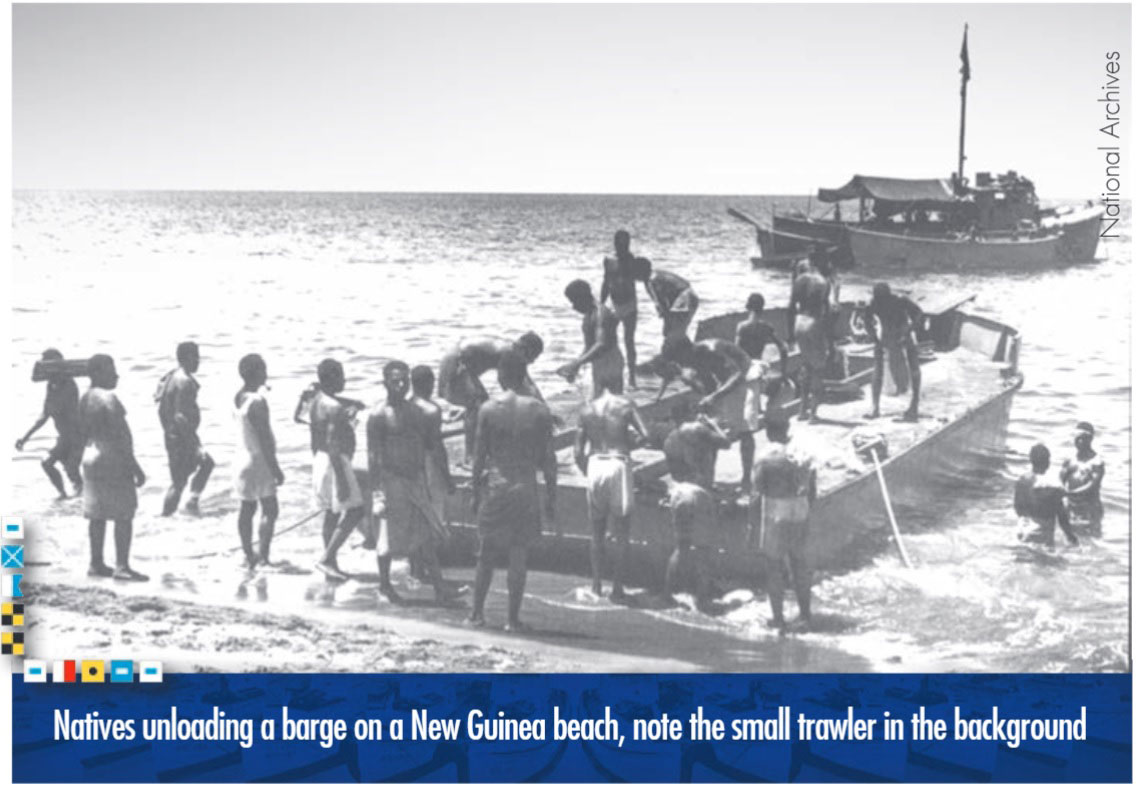 Natives unloading a barge on a New Guinea beach, note the small trawler in the background. Photo from the National Archives.