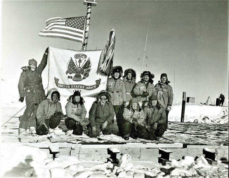 Above, a hero shot of the Army helicopter crews up on the old garage roof, in front of the orange striped bamboo flagpole. From left: kneeling, SP/5 Paul George, 1st Lt. Charles Beaman, Capt. Neal E. Early, CWO John P. D'Angelo, and SP/5 Louis J. Harrison. Standing: SP/5 James C. McCaslin, Captain Frank H. Radspinner, Jr., S/Sgt Robert X. Anderson, CWO Joe R. Griffin, and SP/5 Frank L. MacPherson. U.S. Navy Photo.