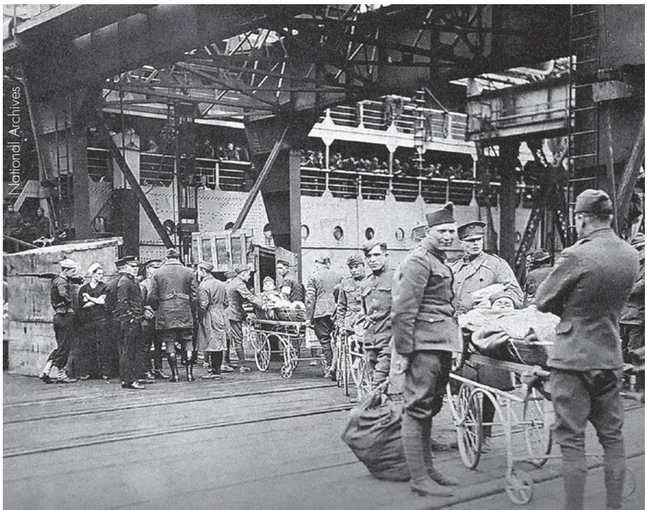 Wounded soldiers are loaded aboard a troop transport for the voyage home.
