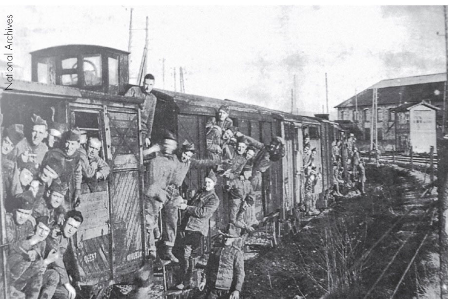 A troop train with U.S. troops loaded into boxcars.