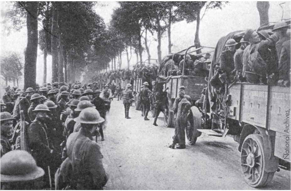 Troops load onto trucks as they prepare to head westward to the embarkation area.