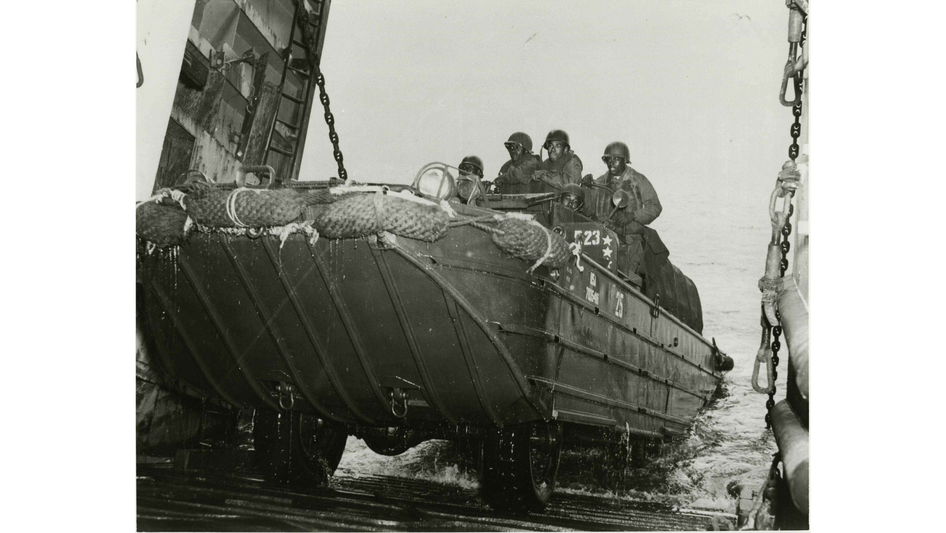 U.S. Army African American troops of the Amphibious Truck Companies supporting the 4th Marine Division at Iwo Jima landings return to the LST.  Part of the research collection of the U.S. Army Transportation Museum.