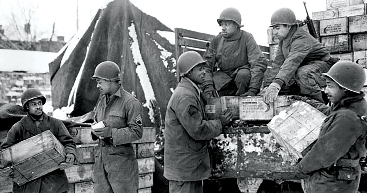 Soldiers from the 4185th Quartermaster Service Company (left to right), Pvt. Harold Hendricks, Staff Sgt. Carl Haines, Sgt. Theodore Cutright, Pvt. Lawrence Buckhalter, Pfc. Horace Deahl, and Pvt. David N. Hatcher, load trucks with rations bound for frontline troops September 1944 in Liege, Belgium. (Photo courtesy of the U.S. Army)