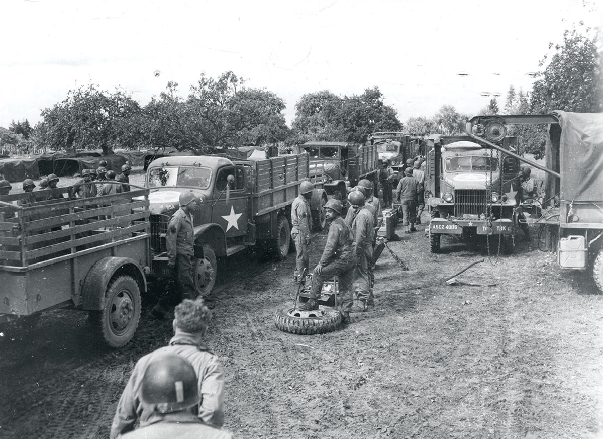 An American truck convoy halts at a makeshift service station 7 September 1944 for servicing and a change of drivers near Saint Denis, France. (Photo courtesy of the U.S. Army)