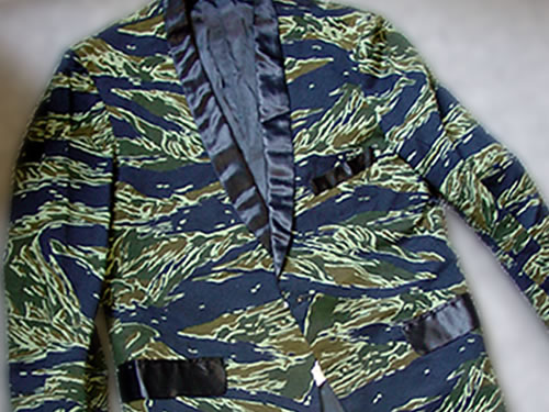 This tiger stripe smoking jacket was worn c. 1967 by LTC Jack Schwartz of the 519th Transportation Battalion which served in Thailand during the Vietnam War.