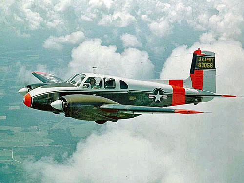 U-8F Seminole in flight in amoungst the clouds.