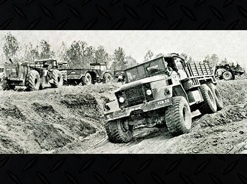 M41 Truck 5 ton cargo truck driving on dirt roads.