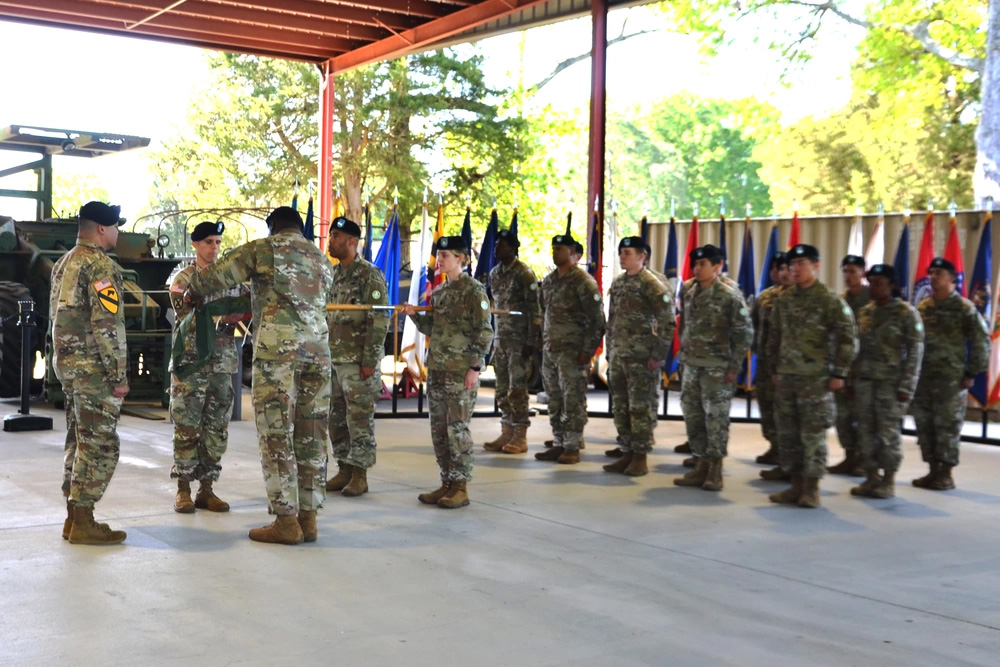 Soldiers assigned to the 689th Rapid Port Opening Element furl and case their unit guidon during a casing ceremony at the U.S. Army Transportation Museum April 23. (Photo: Julie A Kelemen)