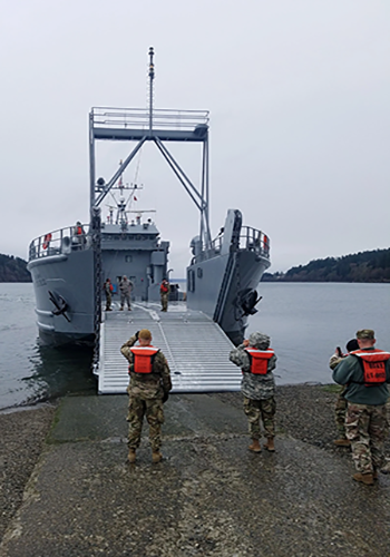 Photo By Staff Sgt. David Lietz | Soldiers prepare a logistics support vessel to receive cargo before the start of a mission in Baltimore, Maryland that is traveling to Washington state. It takes a crew of approximately 35 Soldiers to operate an LSV. They can carry an M1 Abrams tank and operate for extended periods of time on the water. (Courtesy photo by Jake Brand).