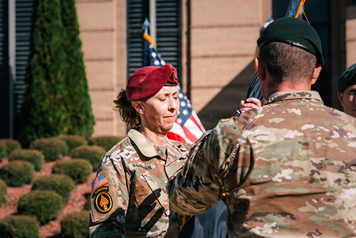 Photo By Sgt. Landon Carter | U.S. Army Command Sgt. Maj. JoAnn Naumann (left) is handed the United States Special Operations Command (USASOC) guidon by U.S. Army Sgt. Maj. Sid Abbott, USASOC Operations Sergeant Major, during the USASOC change of Responsibility ceremony, on Nov. 6, 2025 at Fort Bragg, North Carolina. After two and a half years with Naumann serving in the role, Command Sgt. Maj. David Waldo will now serve as the command's senior enlisted leader. (U.S. Army photo by SSG Landon Carter).