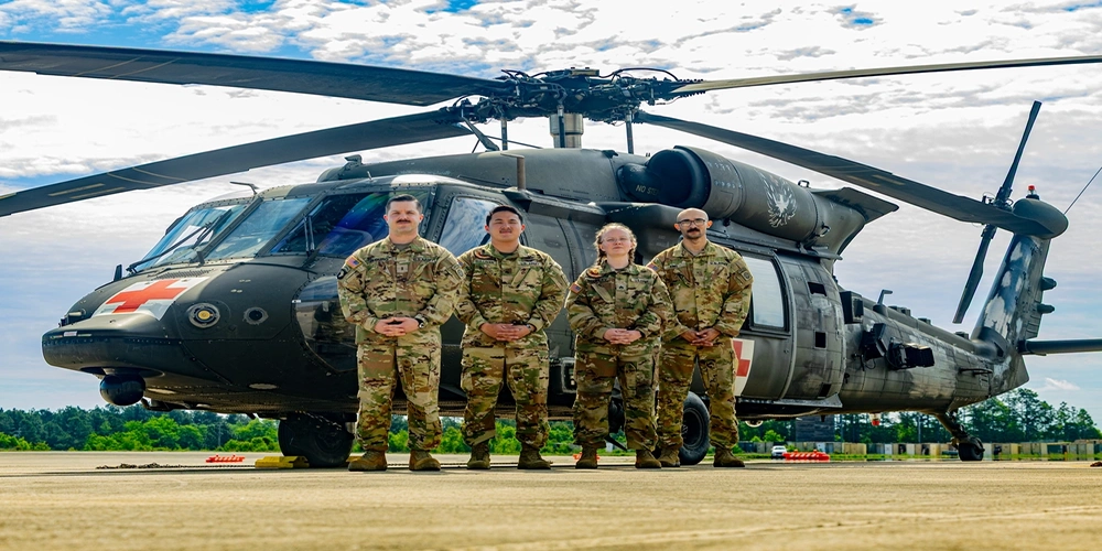 Photo By Sgt. Eli Baker | Flight crew of Charlie Company, 3-82 General Support Aviation Battalion (GSAB) in the 82nd Combat Aviation Brigade (CAB), performed the in-flight prehospital blood transfusion outside of a combat zone within an active Army unit. Since the activation of the installation's whole blood program, flight medics have been authorized to transport blood and administer transfusions during aeromedical evacuations, signifying enhancements to patient survival and prehospital transport.