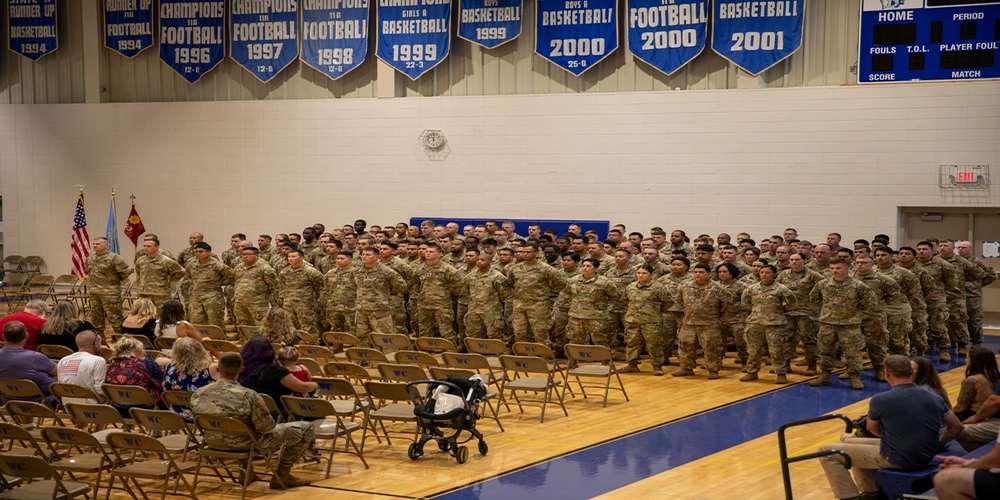 Photo By Maj. Derek Cobb | Soldiers of the 903rd Inland Cargo Transfer Company stand in formation during their Deployment and Farewell Ceremony at West Central High School, in Hartford, South Dakota, on July 11, 2025. Leaders from across the command and congressional members from South Dakota spoke on the importance of the mission and the professionalism of the Soldiers. (U.S. Army Reserve photo by Maj. Derek Cobb, 451st Expeditionary Sustainment Command).