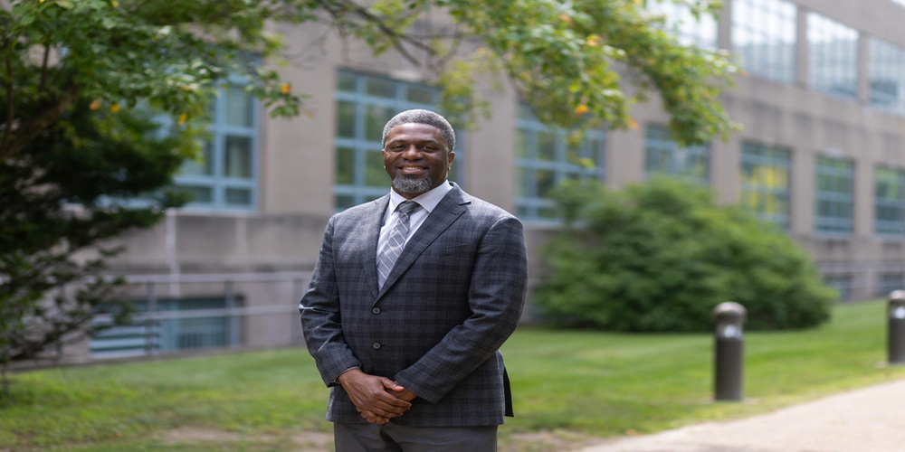 Photo By Kelly Haertjens | Luther Kirby, a logistics management specialist for U.S. Army Sustainment Command’s Third-Party Payment System and Transportation Account Codes, stands outside ASC headquarters at Rock Island Arsenal, Illinois. Kirby makes sure all items within the Army enterprise make it to where they need to go and are paid for, whether it’s a handful of screws or an Abrams M1A2 Main Battle Tank. (Photo by Kelly Haertjens, ASC Public Affairs).
