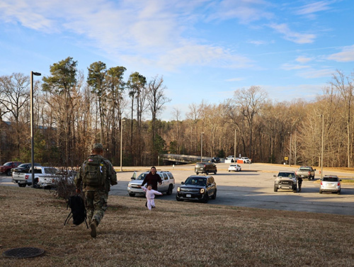 Photo By Dani Johnson | The daughter of a U.S. Army Quartermaster School Advanced Individual Training Soldier runs to greet her Soldier father Dec. 18 at the POV control node on Fort Lee, Va. Fort Lee-based trainees have the option to leave AIT for the two-week holiday period, providing an opportunity to reconnect Soldiers with their families and to share their Army story with the public and their communities. (U.S. Army photo by Dani Johnson).