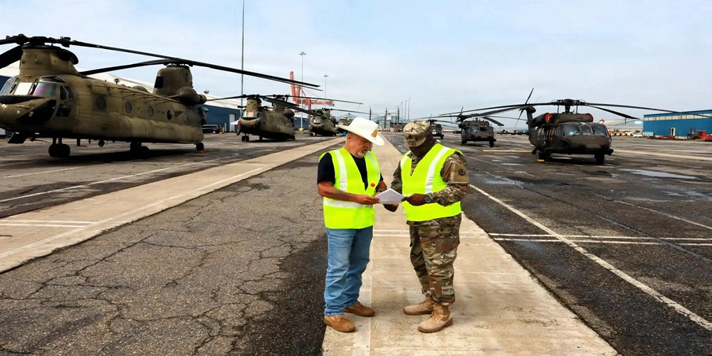 Courtesy Photo | Larry Lawrence, and U.S. Army Master Sgt. Ence Spann, 597th Transportation Brigade, ARTRANS, operations, compare notes during an exercise at the Port of Norfolk, Virginia, summer 2025.