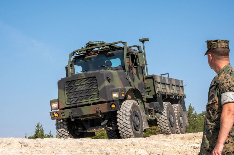 Photo by Melissa Buckley | Marine Gunnery Sgt. Davin Gioacchini, Motor Vehicle Operator Course staff noncommissioned officer-in-charge, helps students negotiate the Marine Corps Detachment’s off-road course Sept. 12 at Fort Leonard Wood Training Area 234.