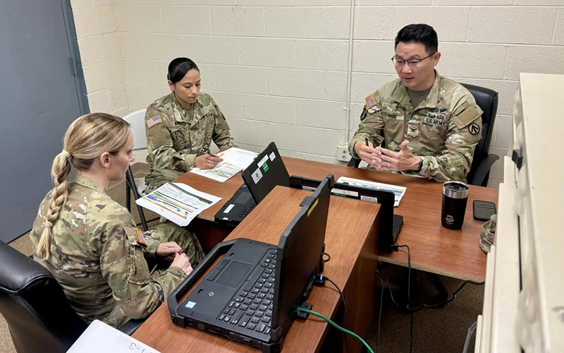 Photo By Staff Sgt. Elizabeth Bryson | U.S. Army majors Kathleen Reimann and Gisselda Nava receive guidance from Colonel Edward K. Woo, 597th Transportation Brigade, SDDC, commander, in the 597th warehouse July 2, 2025, during a communications exercise at Fort Eustis, Va. (U.S. Army photo by Brian Ridgeway).