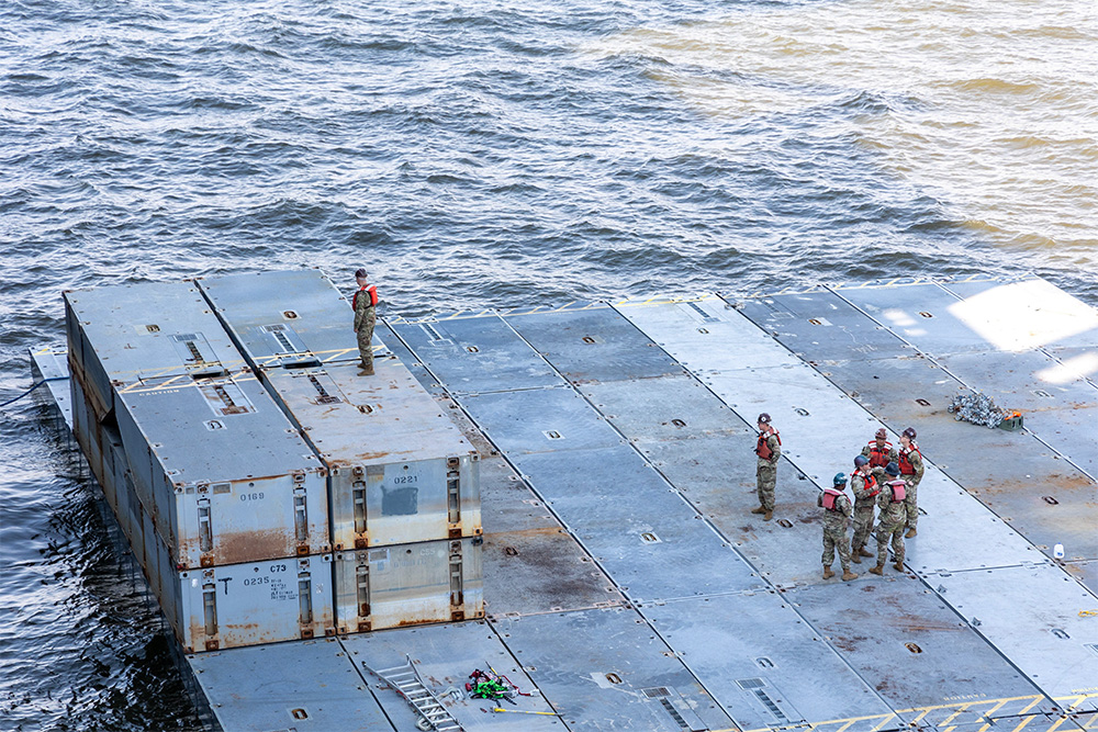 US Army soldiers prepare mobile causeway sections to be loaded aboard MV Roy A. Benavidez on March 15, 2024. (USNI News Photo)