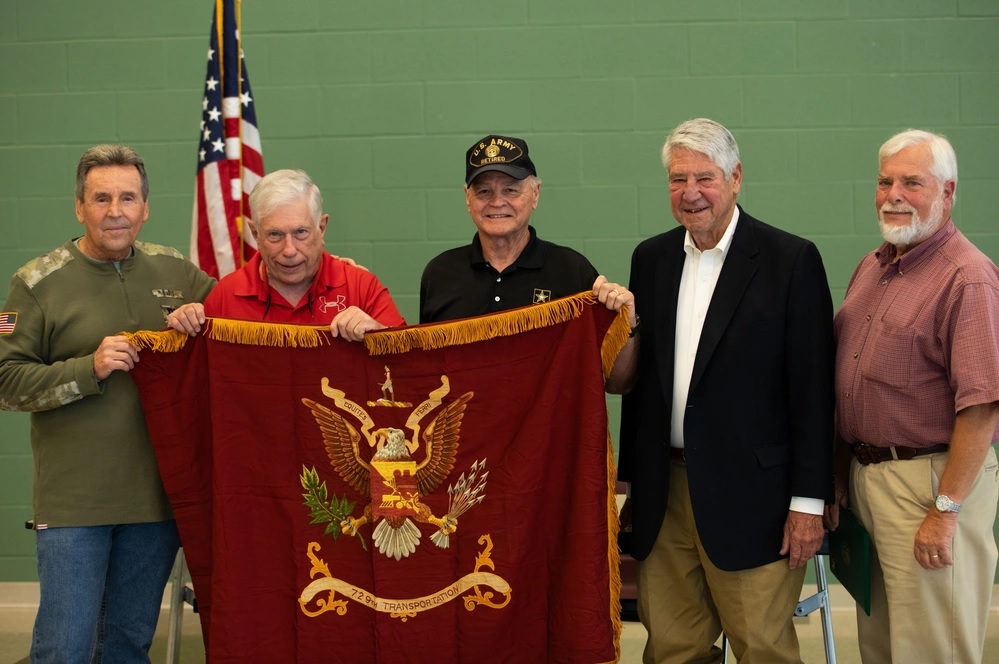 Photo By Sgt. Maria Elena Casneiro | Alumni from the 729th Railway Operating Battalion pose with the unit's historical colors during a ceremony in New Haven, Conn. on Sunday, Sept. 29, 2024, where the colors were returned to U.S. Army Reserve Lt. Col. Roland Foss, commander of the 729th Transportation Battalion, 7th Mission Support Command.