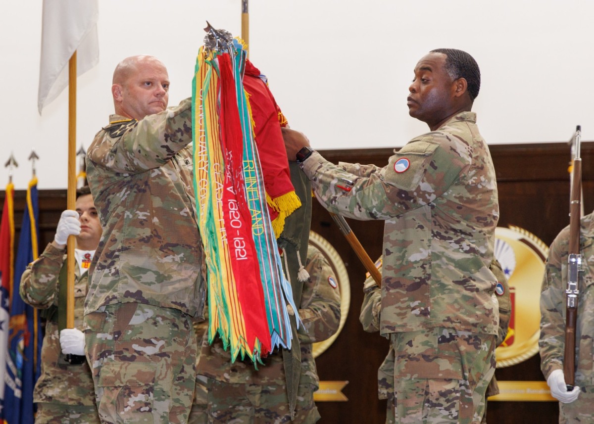 Lt. Col. Erik Hansen, left, commander of the 35th Combat Sustainment Support Battalion, and Command Sgt. Maj. Richard Williams Jr., senior enlisted leader for the battalion, uncase the colors for the 765th Transportation (Terminal) Battalion...