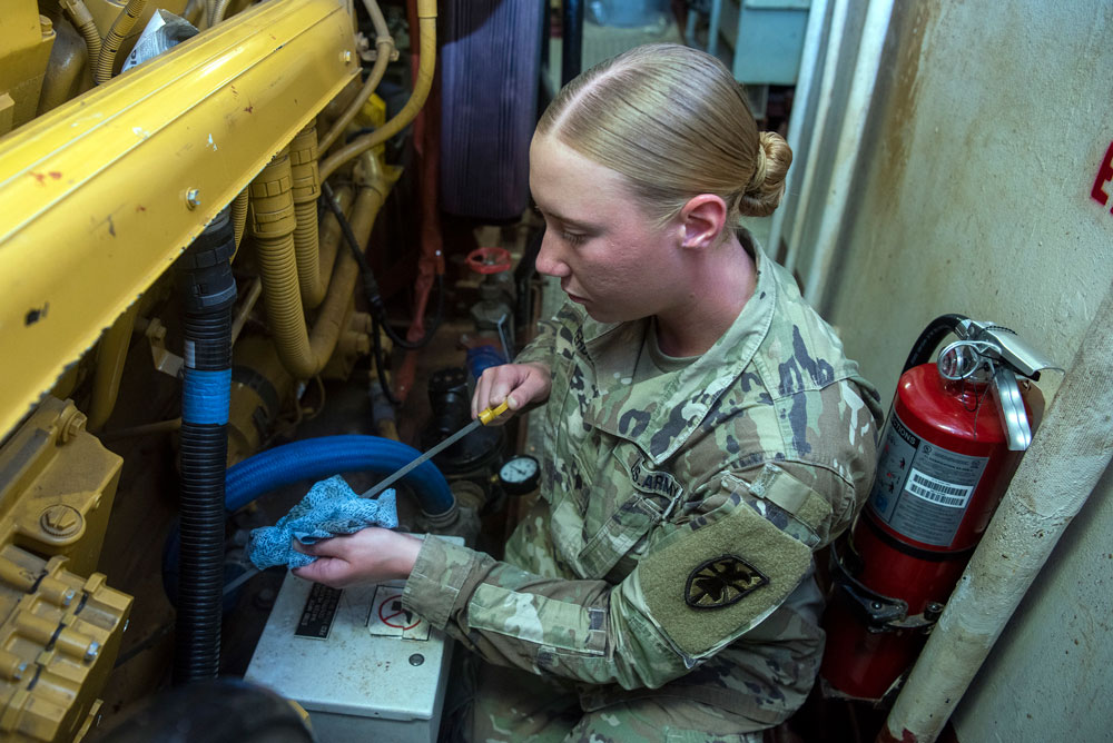 U.S. Army Spc. Sarah Perdue, 329th Composite Watercraft Company, 10th Battalion, engineer, checks the main engine oil level aboard U.S. Army Vessel Missionary Ridge (LCU-2028) at Joint Base Langley-Eustis, Virginia, Aug. 19, 2022. Perdue is assigned to one of the Army’s eight landing craft utility vessels at Langley-Eustis’ Third Port, and is responsible for maintaining the engineering spaces and equipment. (U.S. Air Force Photo by Abraham Essenmacher)