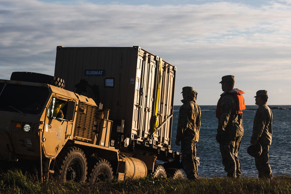 United States Army vehicle successfully lands on the beach from a Floating Causeway in Bowen North Queensland during Exercise Talisman Sabre, marking the opening of Joint Logistics Over the Shore (JLOTS) activities which enables the movement of equipment, machinery and vehicles from vessel to shore. (Photo by Australian Defence Force LAC Adam Abela)