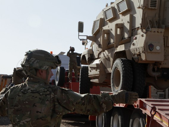 Soldiers loading MRAP on trailer