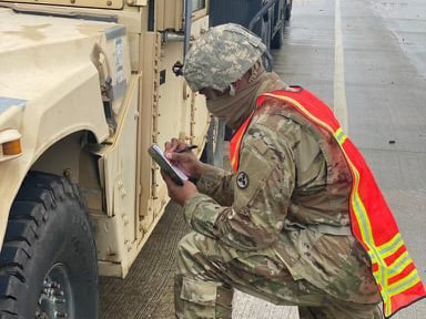 Soldier checking proper documentation prior to loading