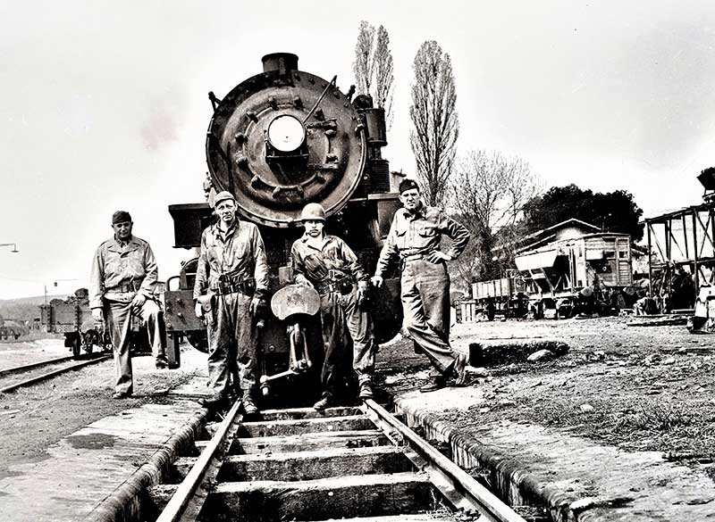 Soldiers standing in front of a U.S. Army train.