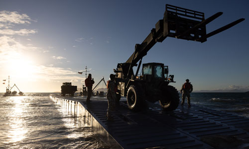 United States Army equipment successfully lands on the beach from a Floating Causeway in Bowen North Queensland during Exercise Talisman Sabre, marking the opening of Joint Logistics Over the Shore (JLOTS) activities which enables the movement of equipment, machinery and vehicles from vessel to shore. (Photo by Australian Defence Force Cpl. Jacob Joseph)