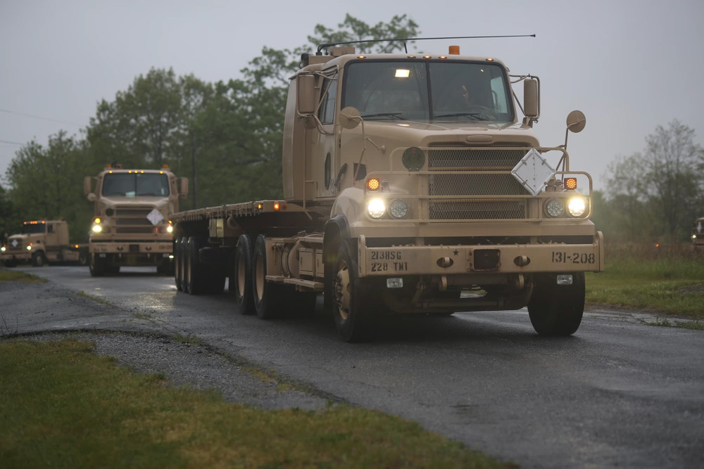U.S. Soldiers with the 131st Transportation Company, 228th Transportation Battalion, 213th Regional Support Group drive M915 tractor trucks in a cross-country convoy during Army Materiel Command's Operation Patriot Press, May 10, 2024. The annual nationwide ammunition redistribution mission supports the Army’s strategic positioning goals. (U.S. Army National Guard photo by Sgt. Du-Marc Mills)