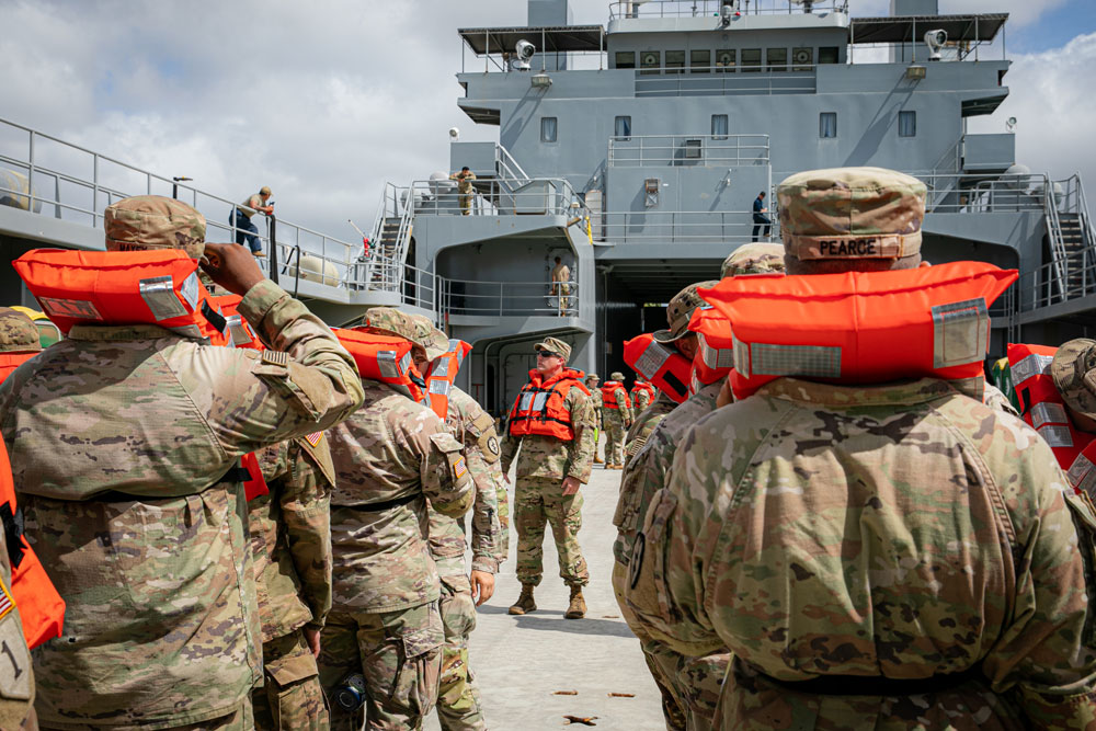 U.S. Army Soldiers with 2nd Battalion, 35 Infantry Regiment, 3rd Infantry Brigade Combat Team, 25th Infantry Division, receive a safety brief from the crew of the United States Army Vessel General Brehon B. Somervell (LSV-3) before setting sail for Hawaii Island on Oct. 17, 2021, on Joint Base Pearl Harbor-Hickam, Hawaii. Sustainment and support elements from the 8th TSC transported maneuver elements for the first time, increasing the operational reach of the U.S. Army. (U.S. Army photos by Spc. Rachel Christensen/28th Public Affairs Detachment)